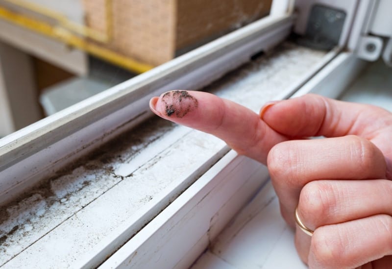womens dirty finger in front of dirty window
