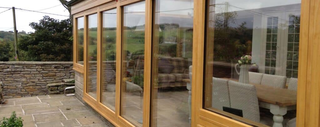 Timber conservatory installation with timber bi-fold doors