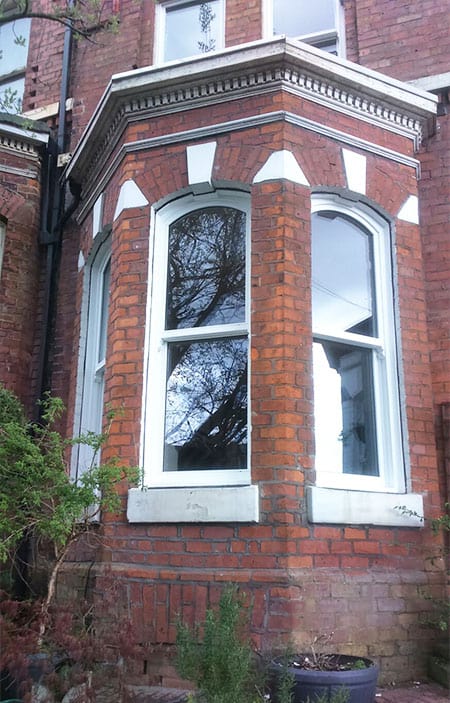 White timber bay sliding sash windows