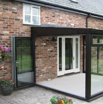 Black uPVC bifolds installed into a conservatory