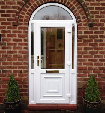A uPVC front door with arched window above